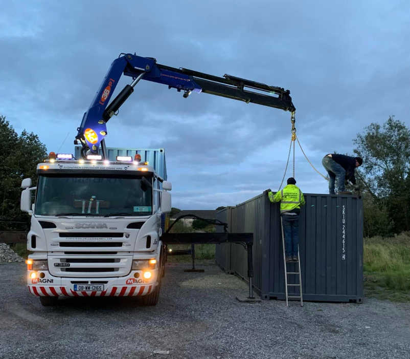 Fitzpatrick Scania crane lifting a container with team on site