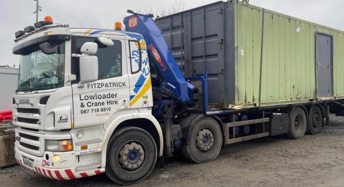 Fitzpatrick Scania crane truck transporting a shipping container